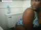 A big black girl pees on the toilet then wipes herself.